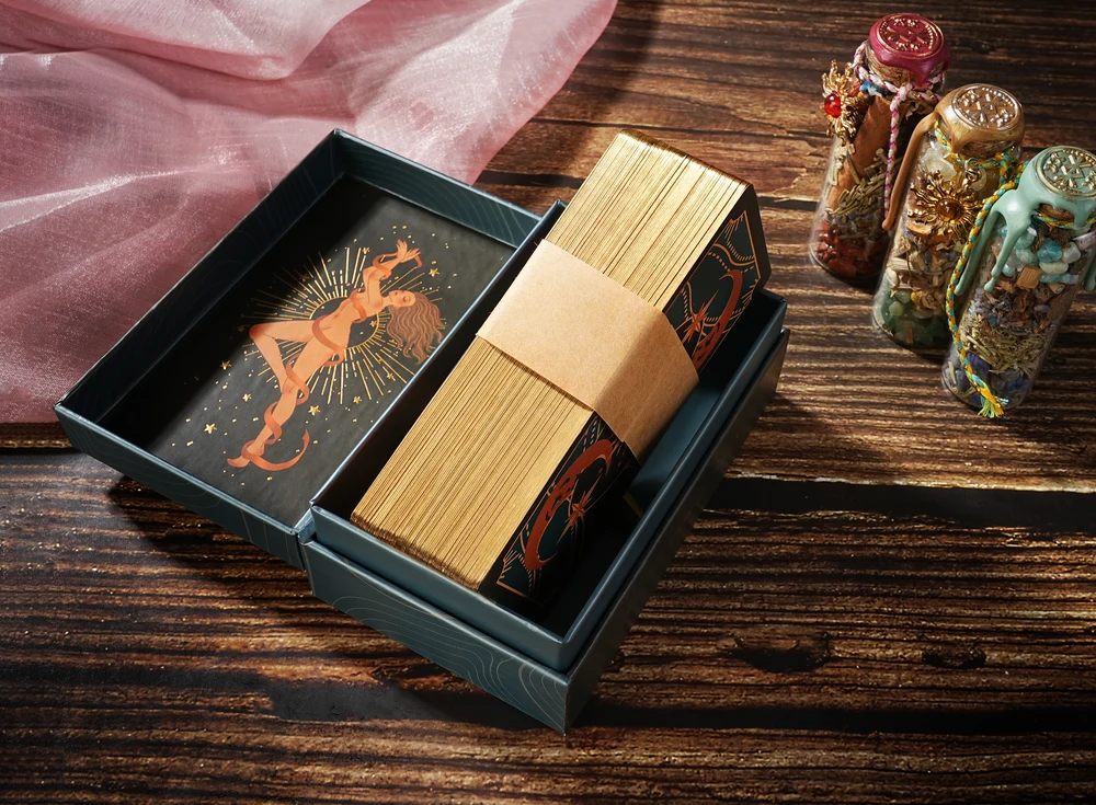 Illustrated tarot cards from the Flaming Muse edition laid out on wood